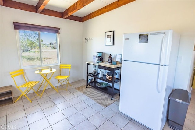 interior space featuring beamed ceiling, baseboards, and light tile patterned floors
