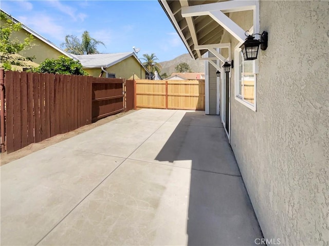 view of patio / terrace featuring a fenced backyard and a mountain view