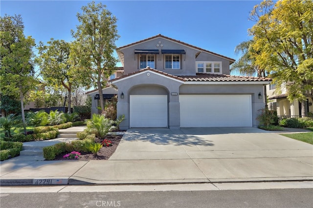 42291 Wildwood Ln, Murrieta, CA 92562 - mediterranean / spanish house featuring a tile roof, an attached garage, stucco siding, and concrete driveway