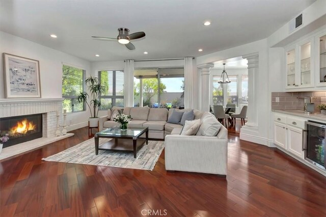 14043 Shepherd Dr, Rancho Cucamonga, CA 91739 - living room featuring decorative columns, beverage cooler, plenty of natural light, a fireplace, and recessed lighting
