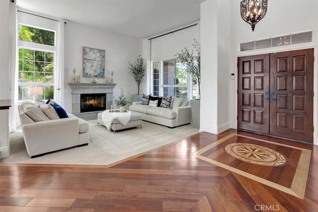 14043 Shepherd Dr, Rancho Cucamonga, CA 91739 - foyer with plenty of natural light, wood-type flooring, a chandelier, a tile fireplace, and a towering ceiling