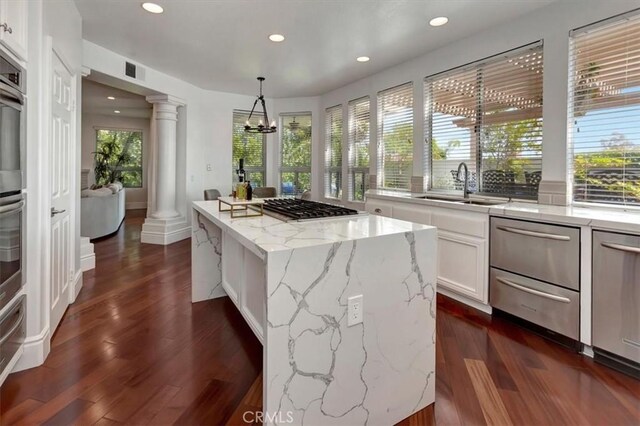14043 Shepherd Dr, Rancho Cucamonga, CA 91739 - kitchen with decorative columns, a sink, recessed lighting, white cabinetry, and stainless steel appliances
