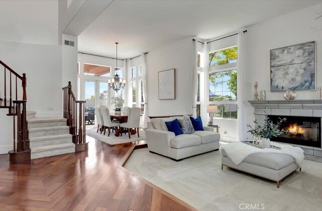 14043 Shepherd Dr, Rancho Cucamonga, CA 91739 - living area with a chandelier, stairway, and a lit fireplace