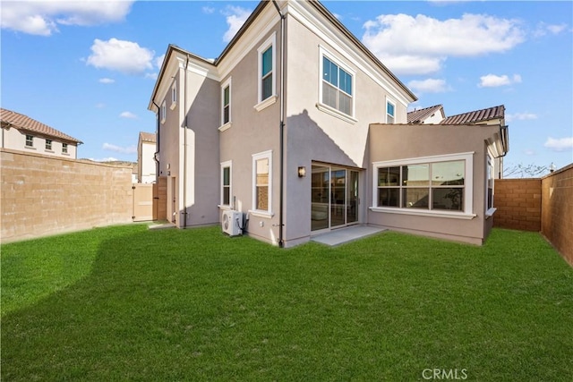 312 Carefree, Irvine, CA 92618 - back of property featuring stucco siding, a fenced backyard, and a lawn