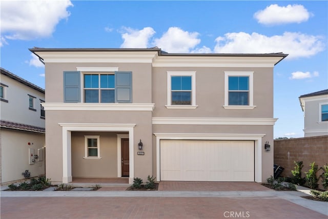 312 Carefree, Irvine, CA 92618 - traditional-style house with a porch, a garage, stucco siding, and decorative driveway