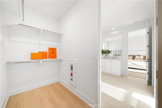 312 Carefree, Irvine, CA 92618 - laundry room with a sink, light wood-style flooring, recessed lighting, and baseboards