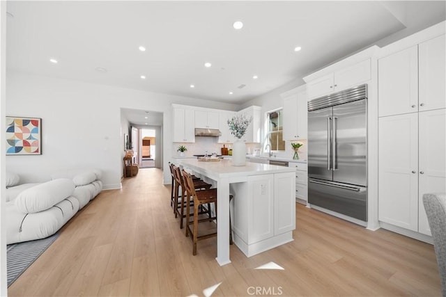 312 Carefree, Irvine, CA 92618 - kitchen with open floor plan, under cabinet range hood, stainless steel built in refrigerator, and a healthy amount of sunlight