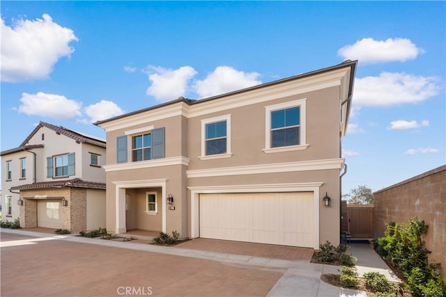 312 Carefree, Irvine, CA 92618 - view of front of property with a garage, stucco siding, fence, and decorative driveway