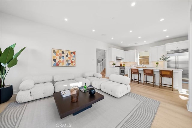 312 Carefree, Irvine, CA 92618 - living area featuring recessed lighting, light wood-style floors, and stairs