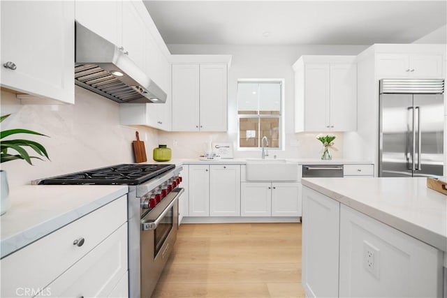 312 Carefree, Irvine, CA 92618 - kitchen with white cabinetry, under cabinet range hood, a sink, light countertops, and high quality appliances