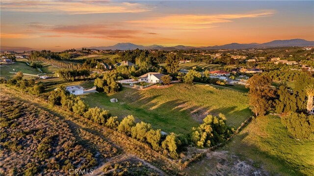 drone / aerial view featuring a mountain view and a rural view