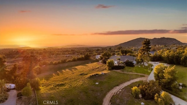 aerial view at dusk featuring a mountain view