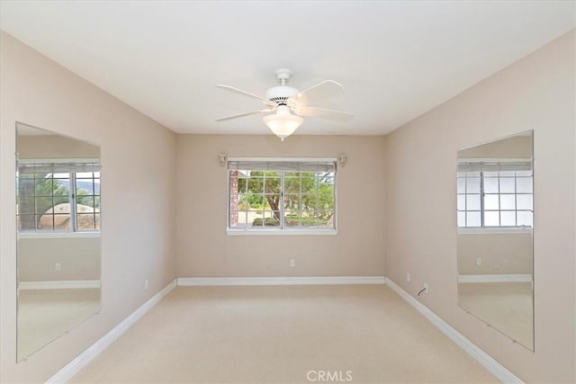 spare room featuring carpet floors, baseboards, and ceiling fan