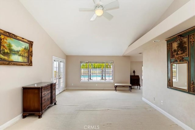 unfurnished room with french doors, baseboards, light colored carpet, and vaulted ceiling