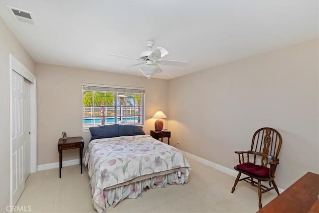 bedroom featuring light carpet, a closet, baseboards, and visible vents