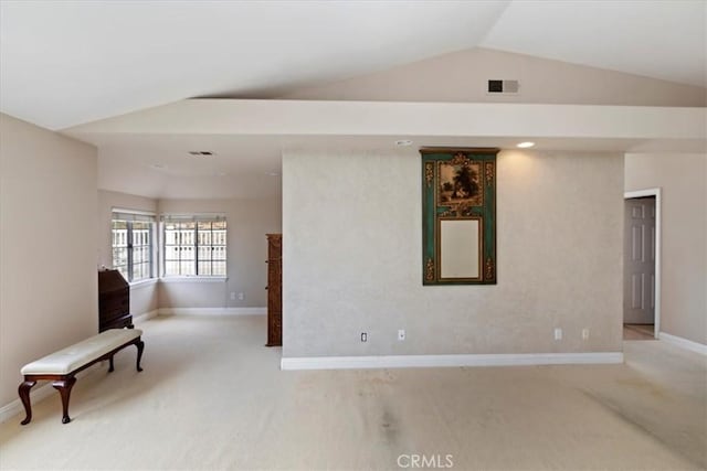 unfurnished room with visible vents, baseboards, lofted ceiling, and carpet floors