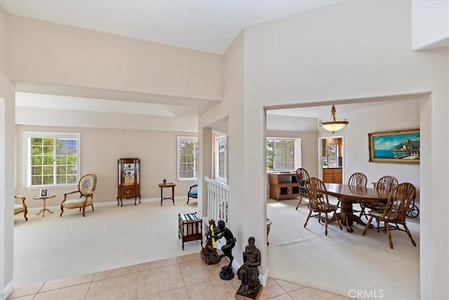 foyer with light carpet, light tile patterned flooring, and baseboards