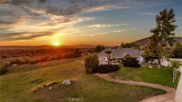 aerial view at dusk featuring a mountain view
