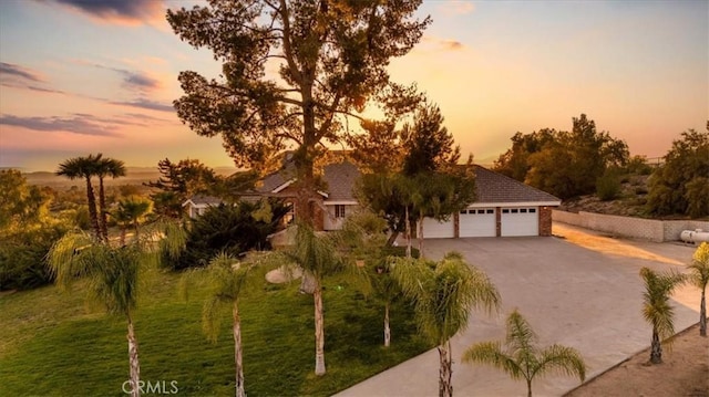 view of front of house with driveway, a front yard, and a garage
