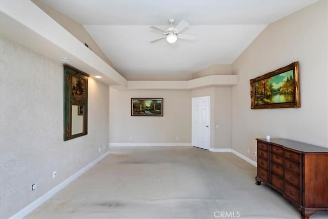 spare room with ceiling fan, baseboards, light carpet, and lofted ceiling