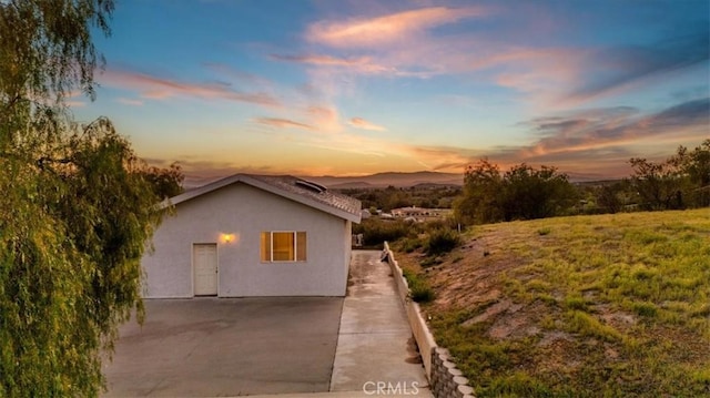 property exterior at dusk with stucco siding