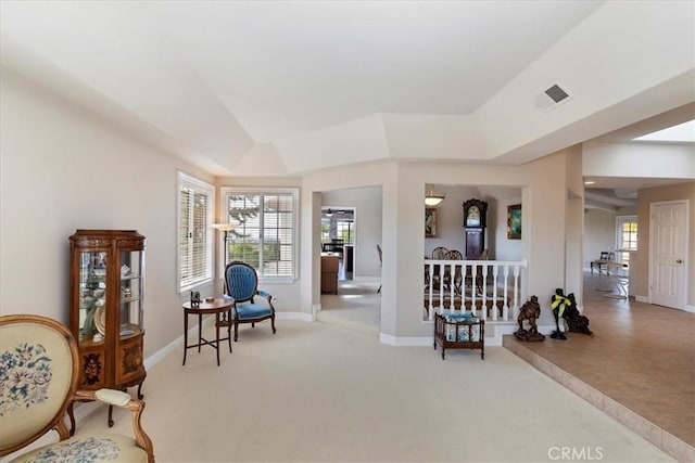 living area featuring carpet flooring, baseboards, and visible vents