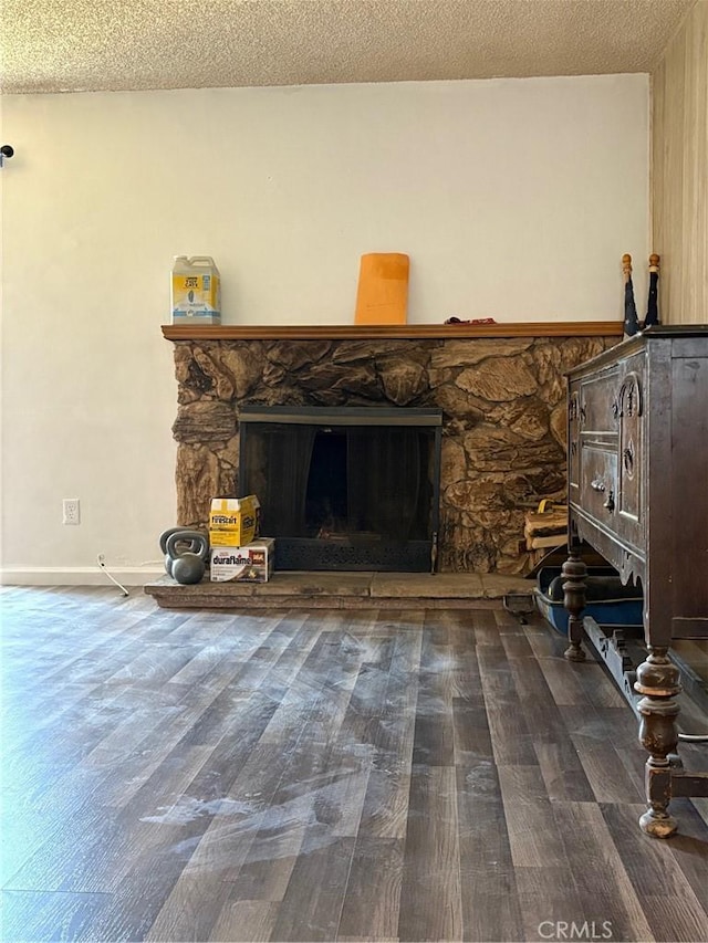 3670 Upper Terrace Dr, Riverside, CA 92505 - unfurnished living room featuring wood finished floors, a textured ceiling, a stone fireplace, and baseboards