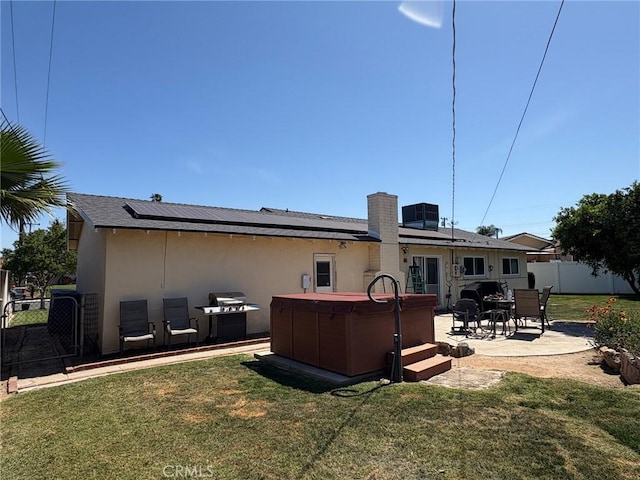 3670 Upper Terrace Dr, Riverside, CA 92505 - back of property with a hot tub, stucco siding, solar panels, and a patio