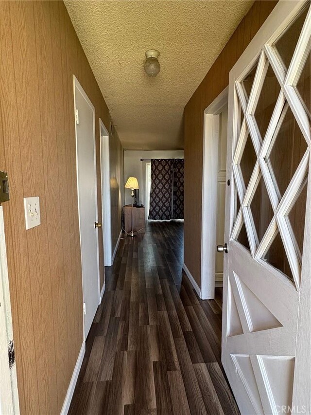 3670 Upper Terrace Dr, Riverside, CA 92505 - hall with wood finished floors, a textured ceiling, baseboards, and wood walls