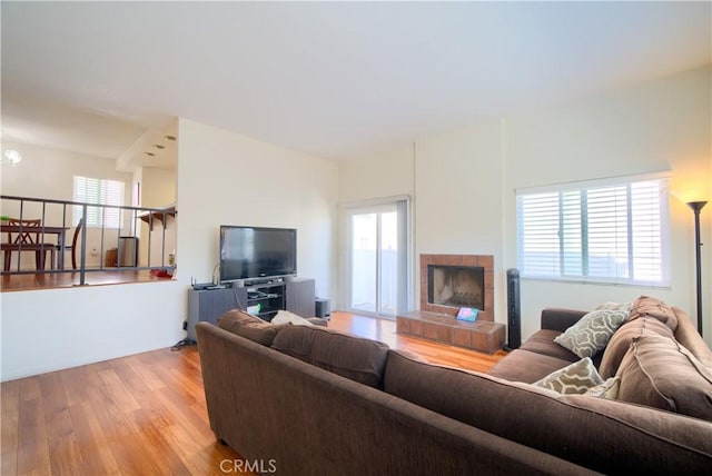 living area with wood finished floors and a fireplace