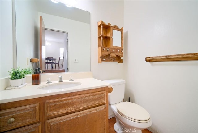 half bathroom with toilet and vanity