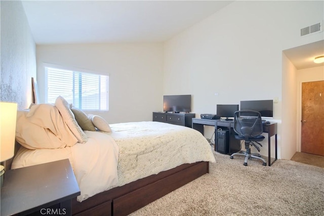 carpeted bedroom featuring visible vents and lofted ceiling