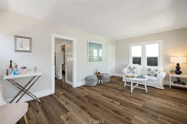 living room featuring a healthy amount of sunlight, wood finished floors, and baseboards