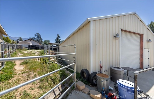 view of outbuilding with a mountain view, an outdoor structure, and an exterior structure