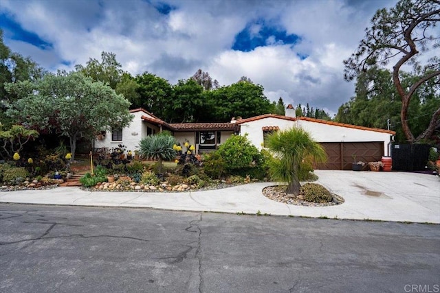 4210 Black Mountain Rd, La Mesa, CA 91941 - mediterranean / spanish house with concrete driveway, a chimney, an attached garage, and stucco siding