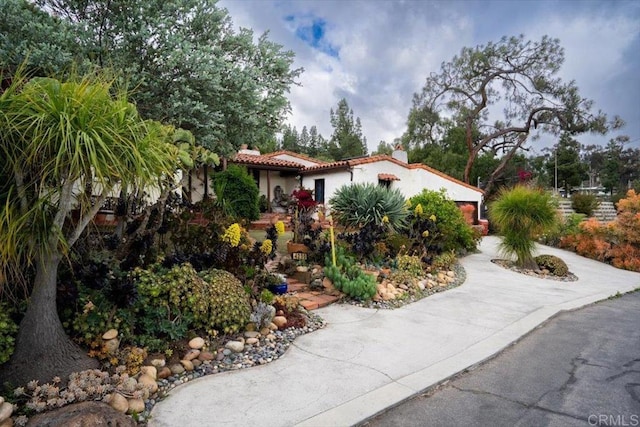 4210 Black Mountain Rd, La Mesa, CA 91941 - mediterranean / spanish house featuring a chimney, concrete driveway, stucco siding, and an attached garage