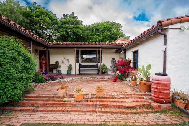 4210 Black Mountain Rd, La Mesa, CA 91941 - doorway to property featuring a patio area, stucco siding, and a tiled roof