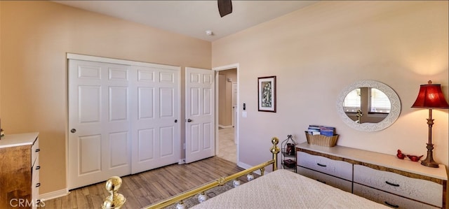 bedroom with wood finished floors, a closet, a ceiling fan, and baseboards