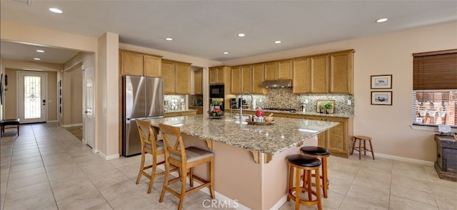 kitchen featuring a breakfast bar, recessed lighting, light tile patterned flooring, decorative backsplash, and stainless steel appliances