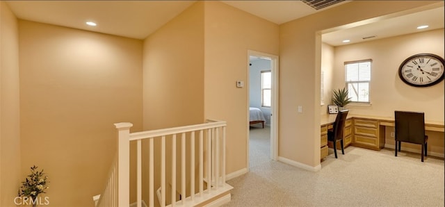 hall with visible vents, an upstairs landing, light colored carpet, and recessed lighting
