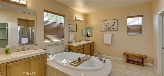 full bathroom with a shower stall, tile patterned floors, a garden tub, and a sink
