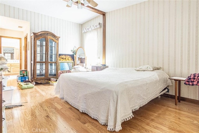 7040 Kenyon Ave, Hesperia, CA 92345 - bedroom with wallpapered walls, wood finished floors, and ceiling fan
