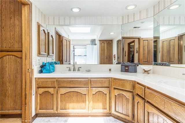 7040 Kenyon Ave, Hesperia, CA 92345 - full bath with wallpapered walls, double vanity, and a sink