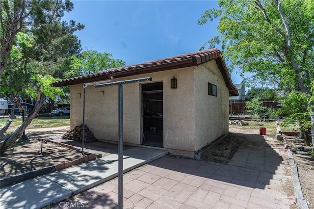 7040 Kenyon Ave, Hesperia, CA 92345 - rear view of house with a patio area, a tile roof, and stucco siding
