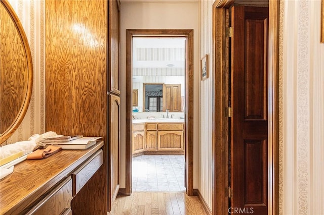 7040 Kenyon Ave, Hesperia, CA 92345 - bathroom featuring wood finished floors, vanity, and wallpapered walls