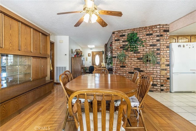 7040 Kenyon Ave, Hesperia, CA 92345 - dining area with visible vents, ceiling fan, light tile patterned floors, and a textured ceiling