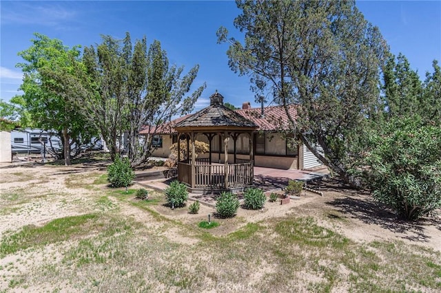 7040 Kenyon Ave, Hesperia, CA 92345 - exterior space with a tile roof, a gazebo, stucco siding, and a chimney