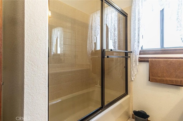 7040 Kenyon Ave, Hesperia, CA 92345 - bathroom with shower / bath combination with glass door and a textured wall