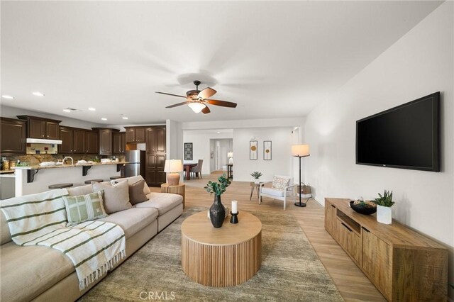 73992 Van Gogh Dr, Palm Desert, CA 92211 - living area with light wood finished floors, a ceiling fan, and recessed lighting
