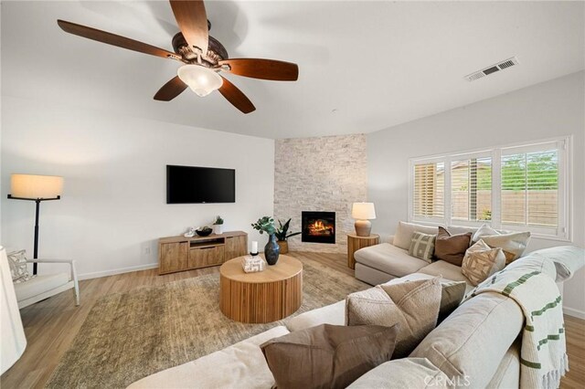 73992 Van Gogh Dr, Palm Desert, CA 92211 - living area with light wood-style floors, a fireplace, baseboards, and a ceiling fan
